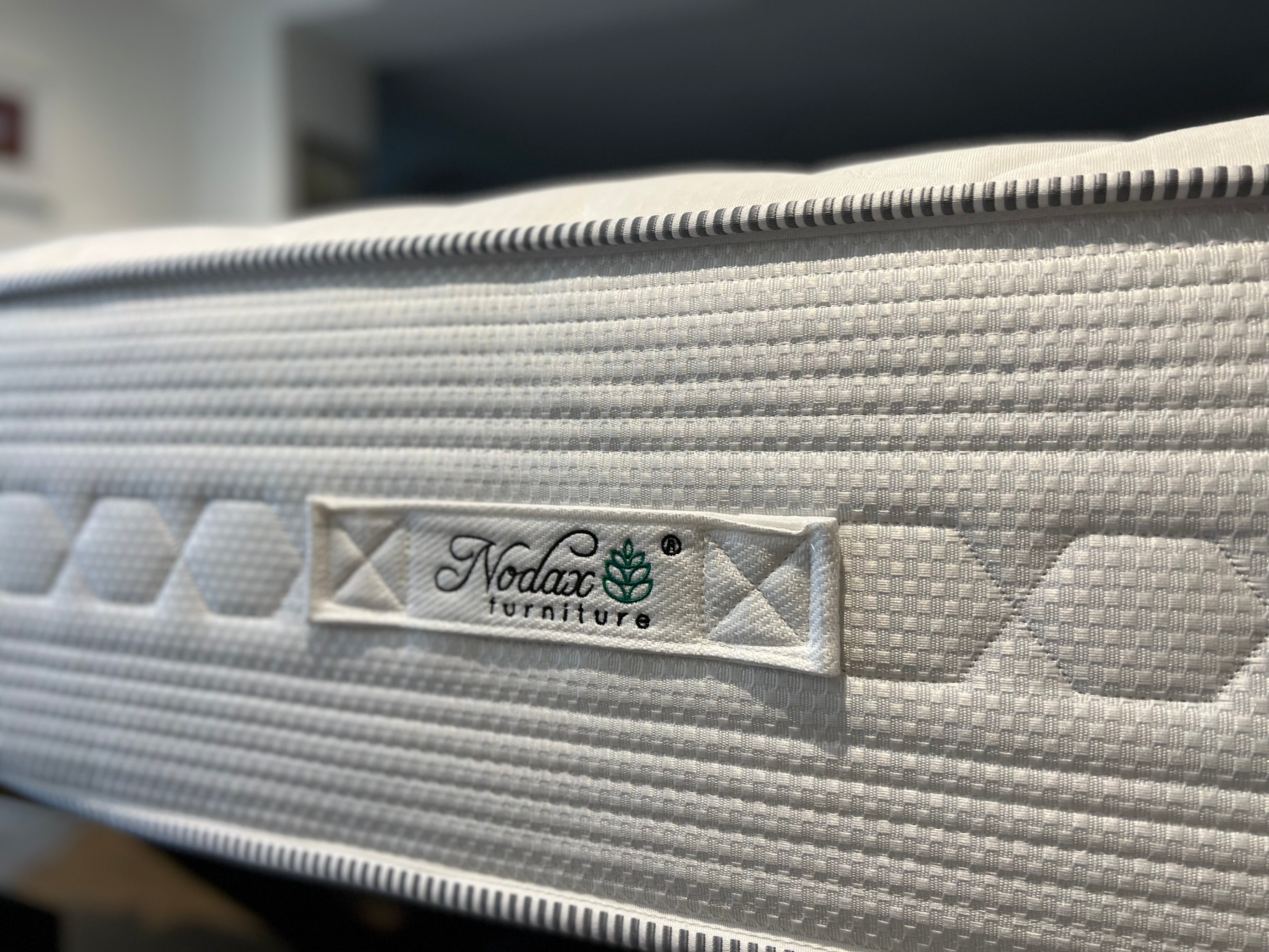 A happy sleeping woman with a Nodax mattress