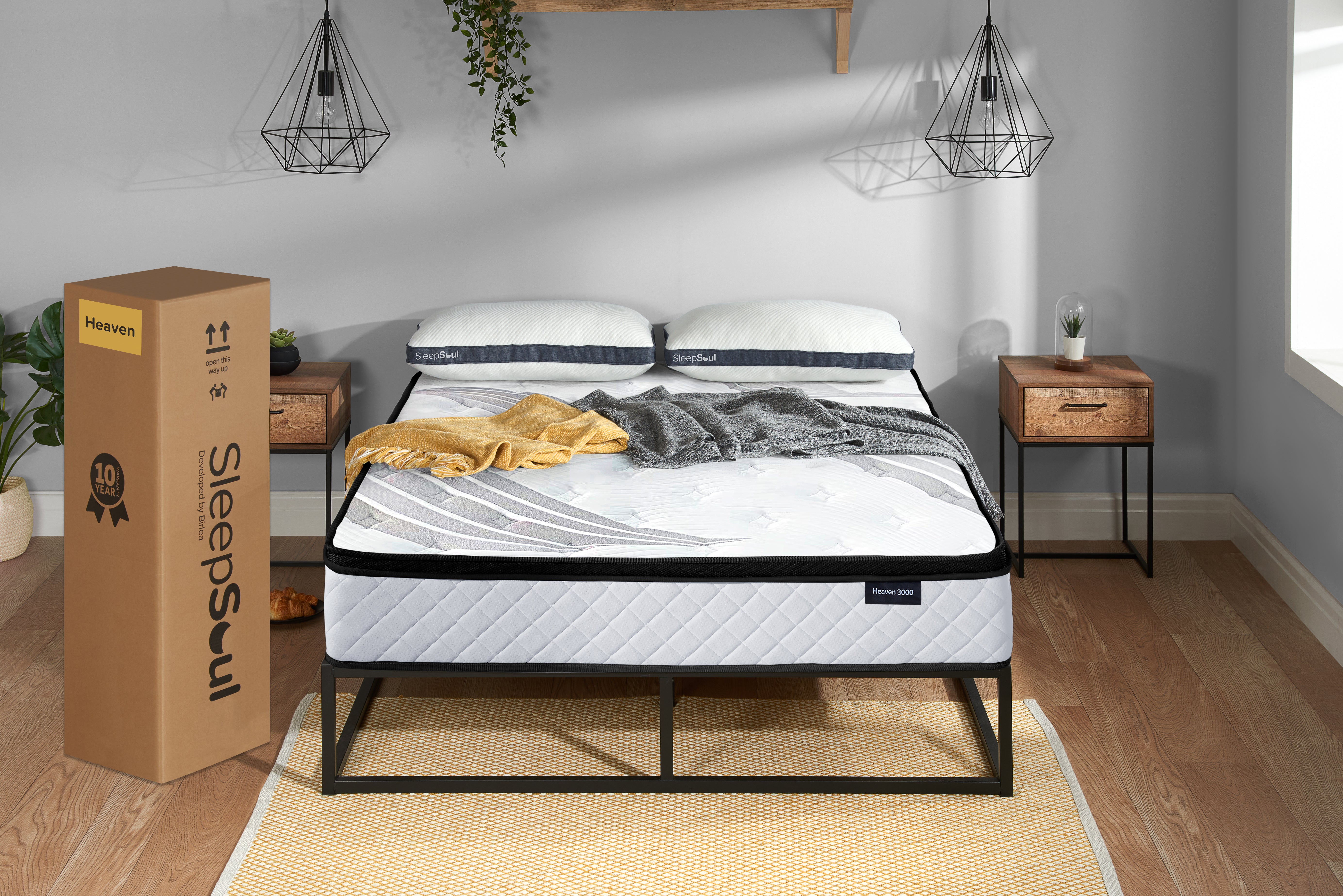 SleepSoul Heaven 3000 pocket spring mattress on a metal bed frame in minimalist bedroom, with mattress box alongside